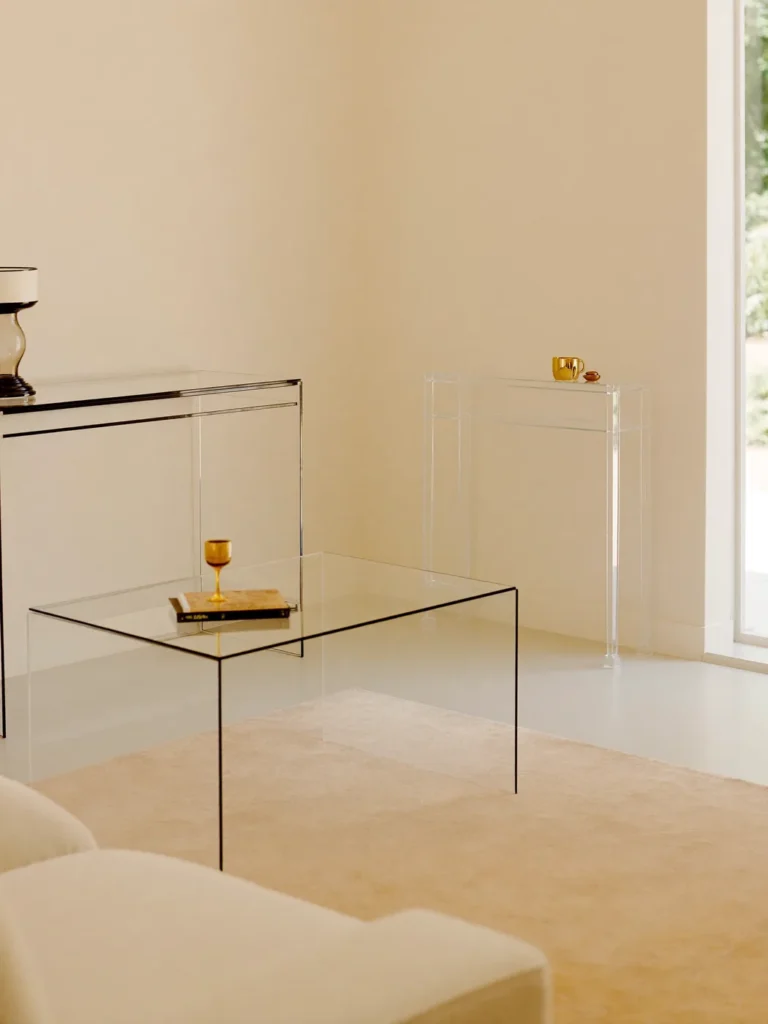 Petit salon agrandi par du mobilier en plexiglas transparent, table basse et console claires